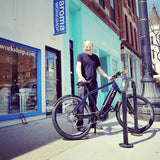 Man Standing with Blue Bicycle